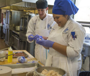Culinary students prepare seafood for a cook-off