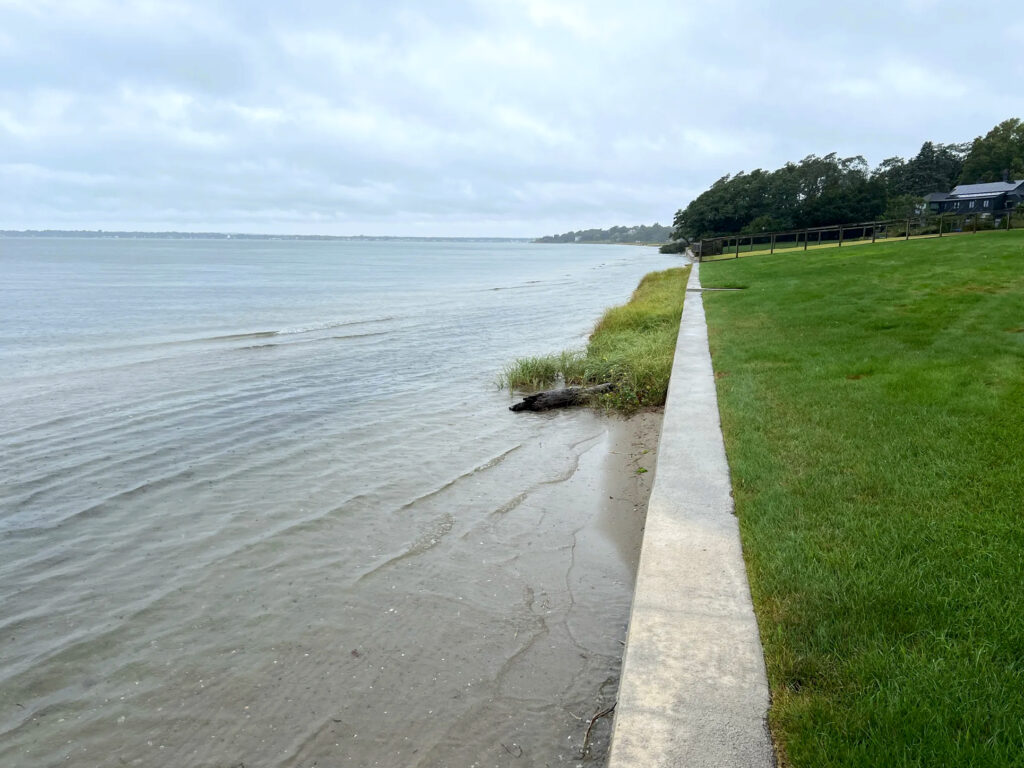 High tide reaches a seawall on Barrington Town Beach during a king tide