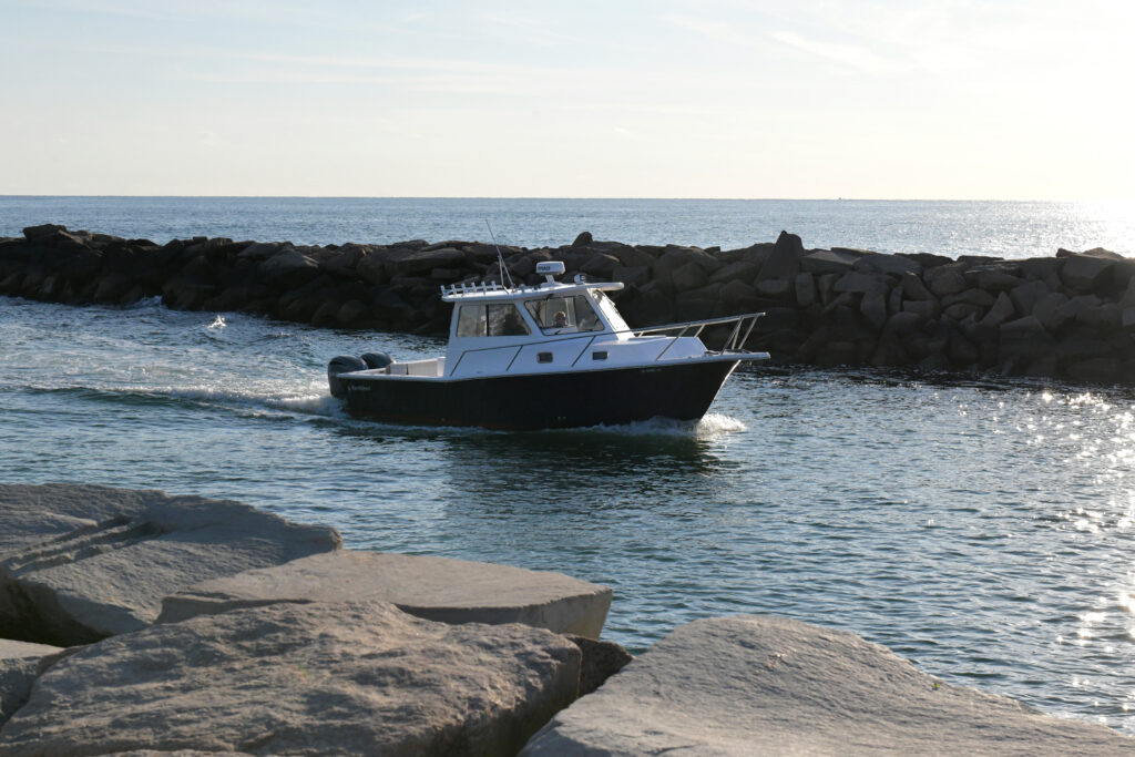 A small boat passes through the breachway