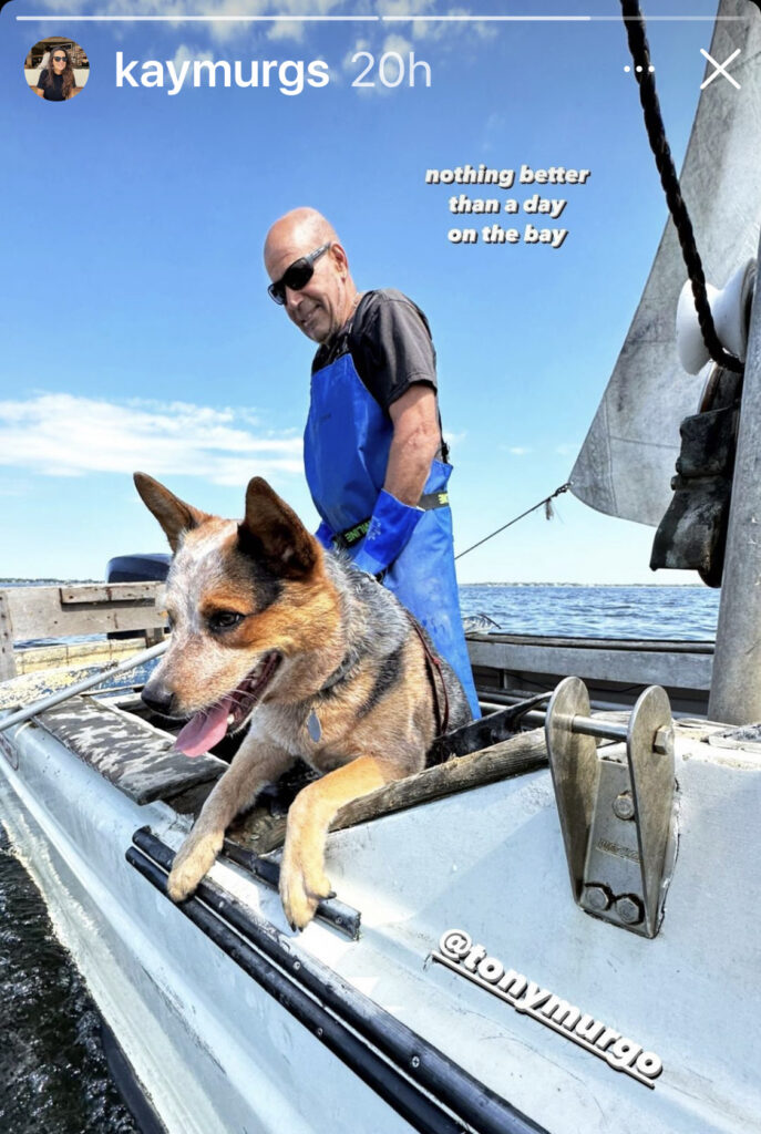 Tony Murgo with his dog on a boat