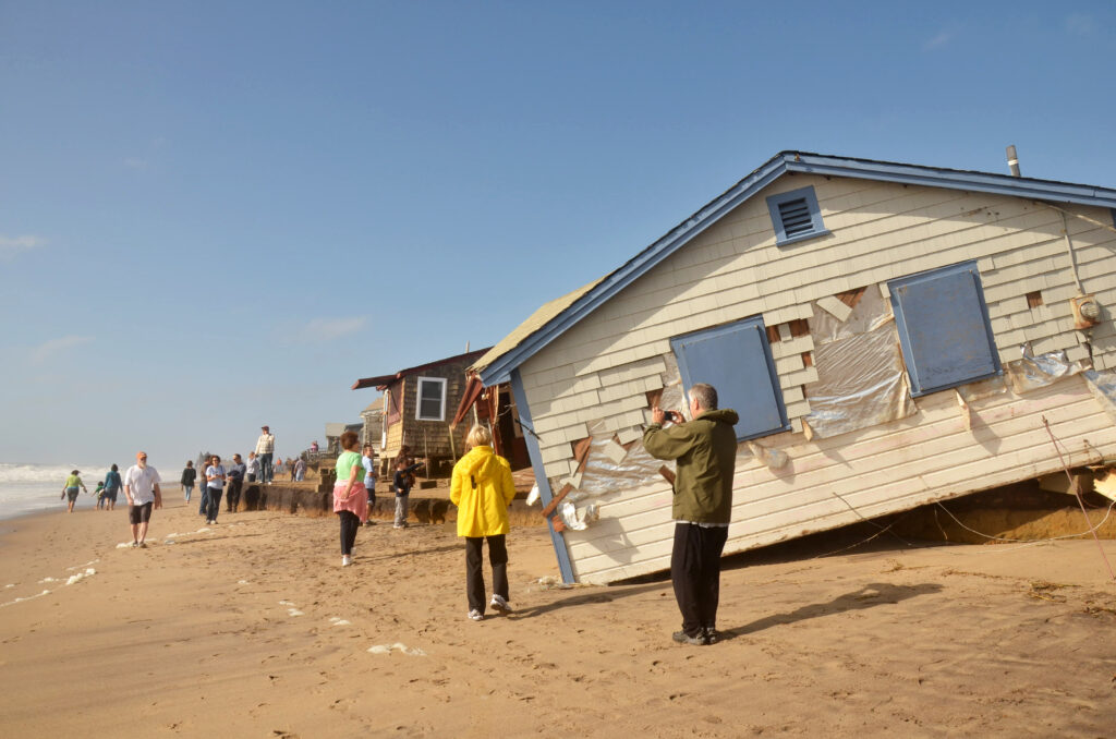 A man photographs destruction at Roy Carpenter's Beach after Superstorm Sandy