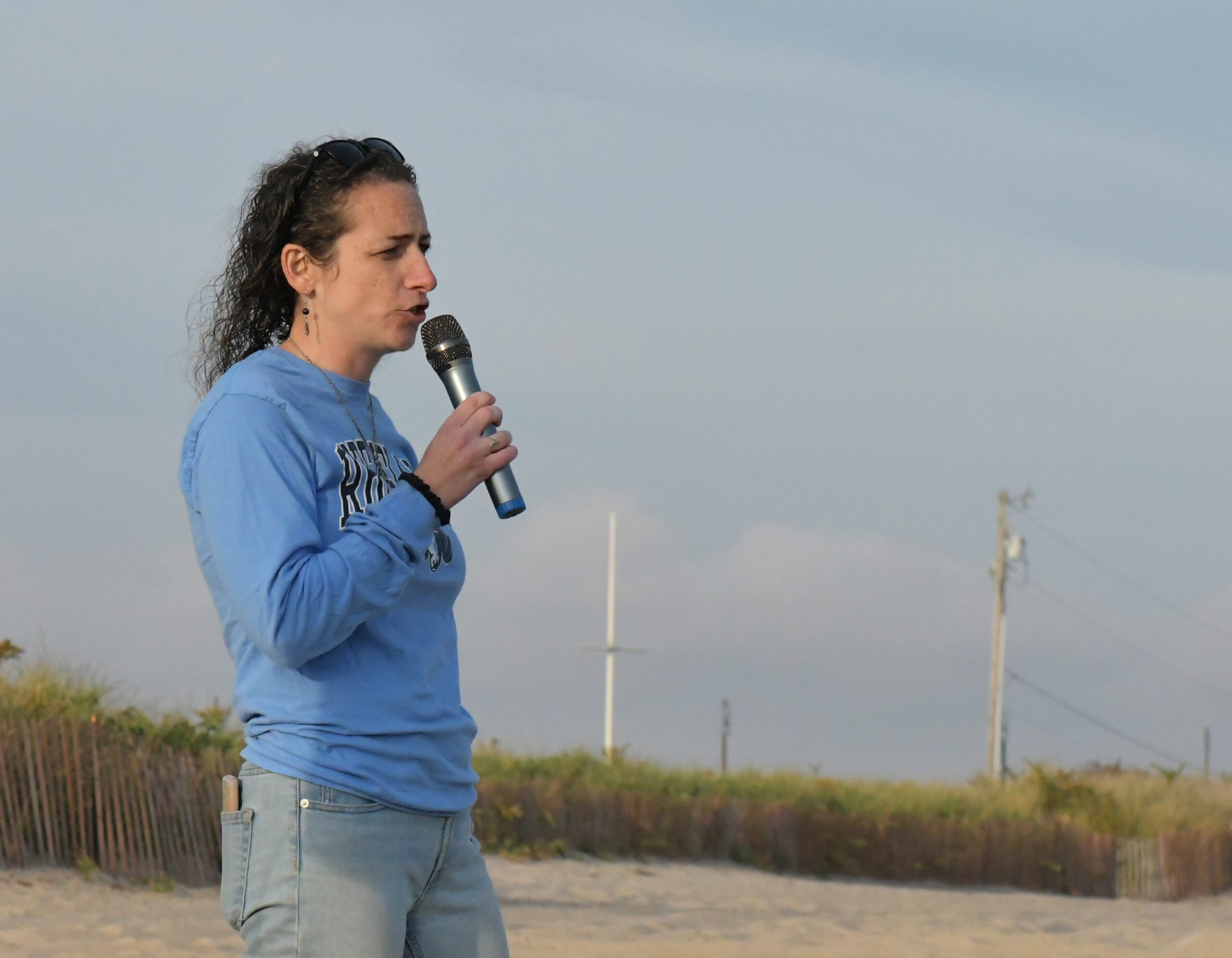 DSC_6705_casey Casey Tremper speaks into a microphone at an event at the Charlestown Breachway