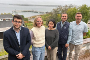 Project leaders stand together outside at the URI GSO campus