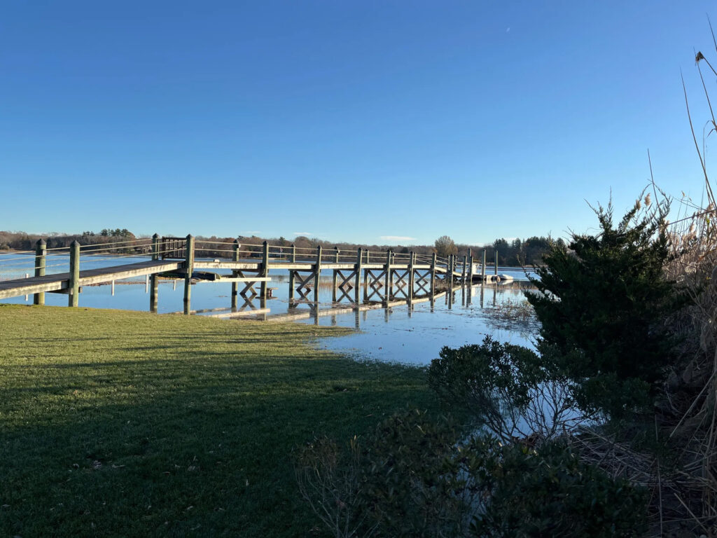 Flooding of a grassy area with a boardwalk in Warren