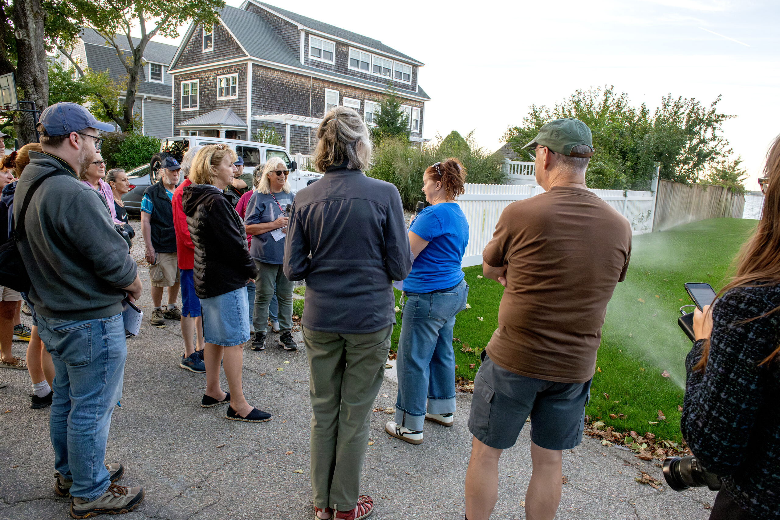 DSC_8329-sprinklers CRMC's Laura Dwyer speaks to walk particpants in front of a right-of-way with active sprinklers