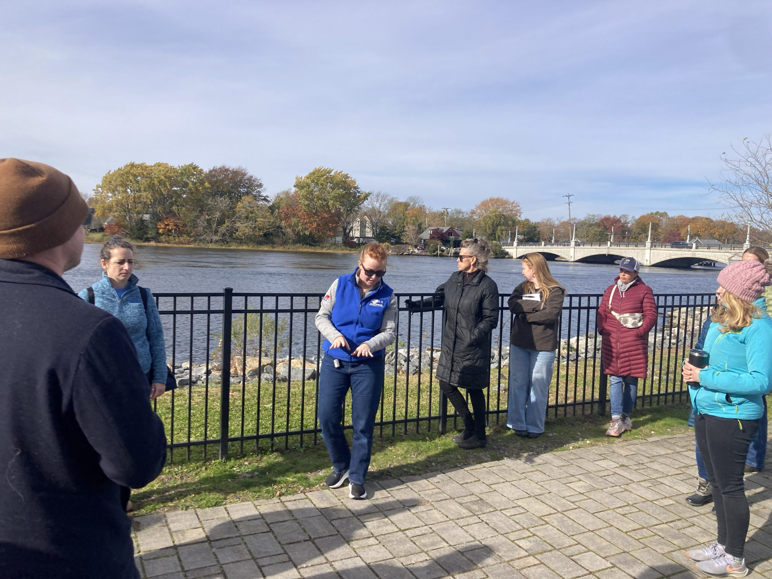 State Sen. Mark McKenney speaks to a group of walk participants in front of a shoreline right-of-way sign