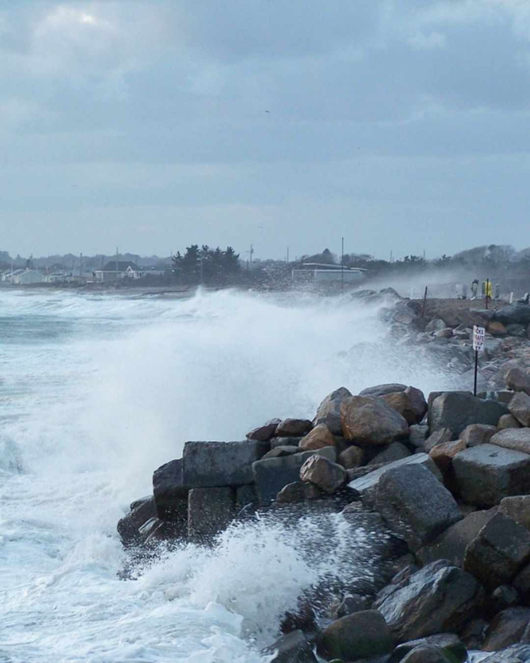 Strong waves and wind crash against the revetment near Roy Carpenter beach